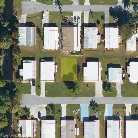 an aerial view of multiple houses with a yard