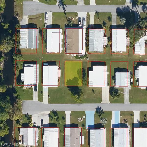 an aerial view of multiple houses with a yard