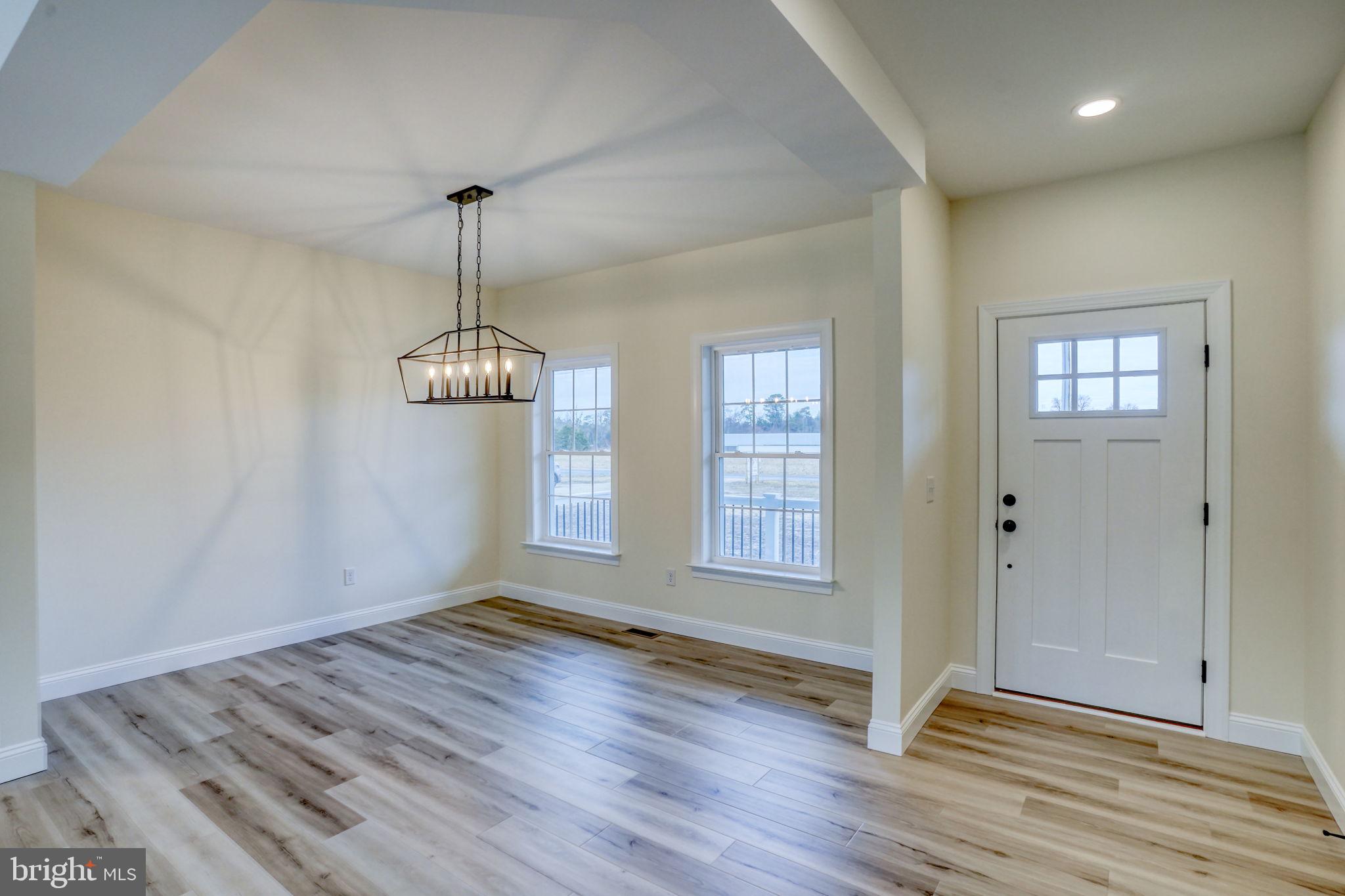 3150 Old Sharptown Road Laurel, DE 19956 - Photo 14 of 46 an empty room with wooden floor and windows