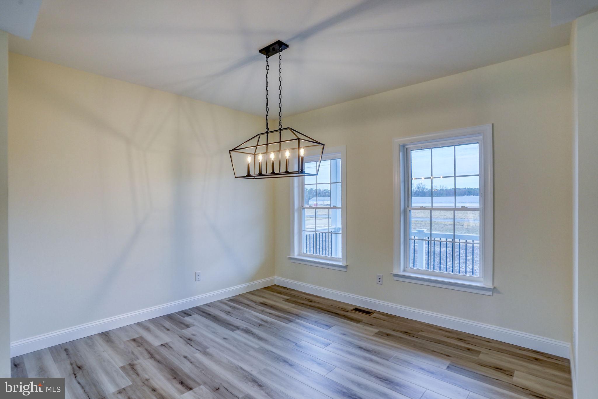3150 Old Sharptown Road Laurel, DE 19956 - Photo 16 of 46 a view of an empty room with wooden floor and a window