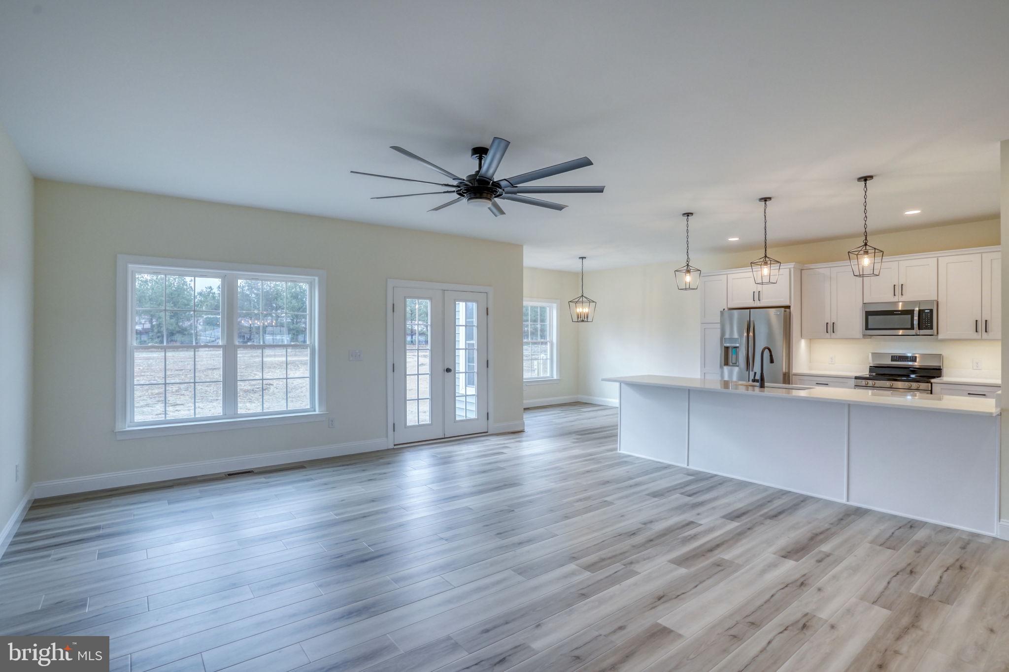 3150 Old Sharptown Road Laurel, DE 19956 - Photo 17 of 46 a large kitchen with cabinets wooden floor and stainless steel appliances
