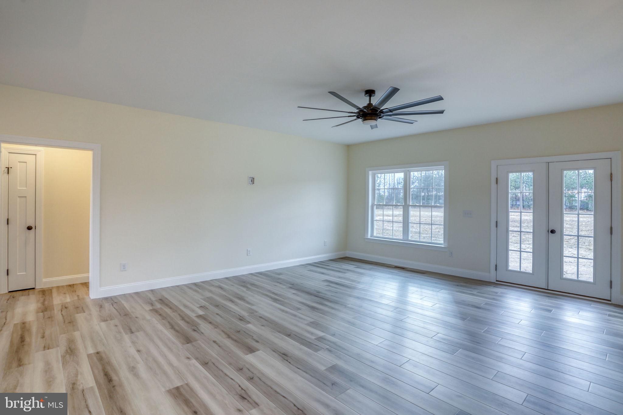 3150 Old Sharptown Road Laurel, DE 19956 - Photo 18 of 46 an empty room with wooden floor and windows