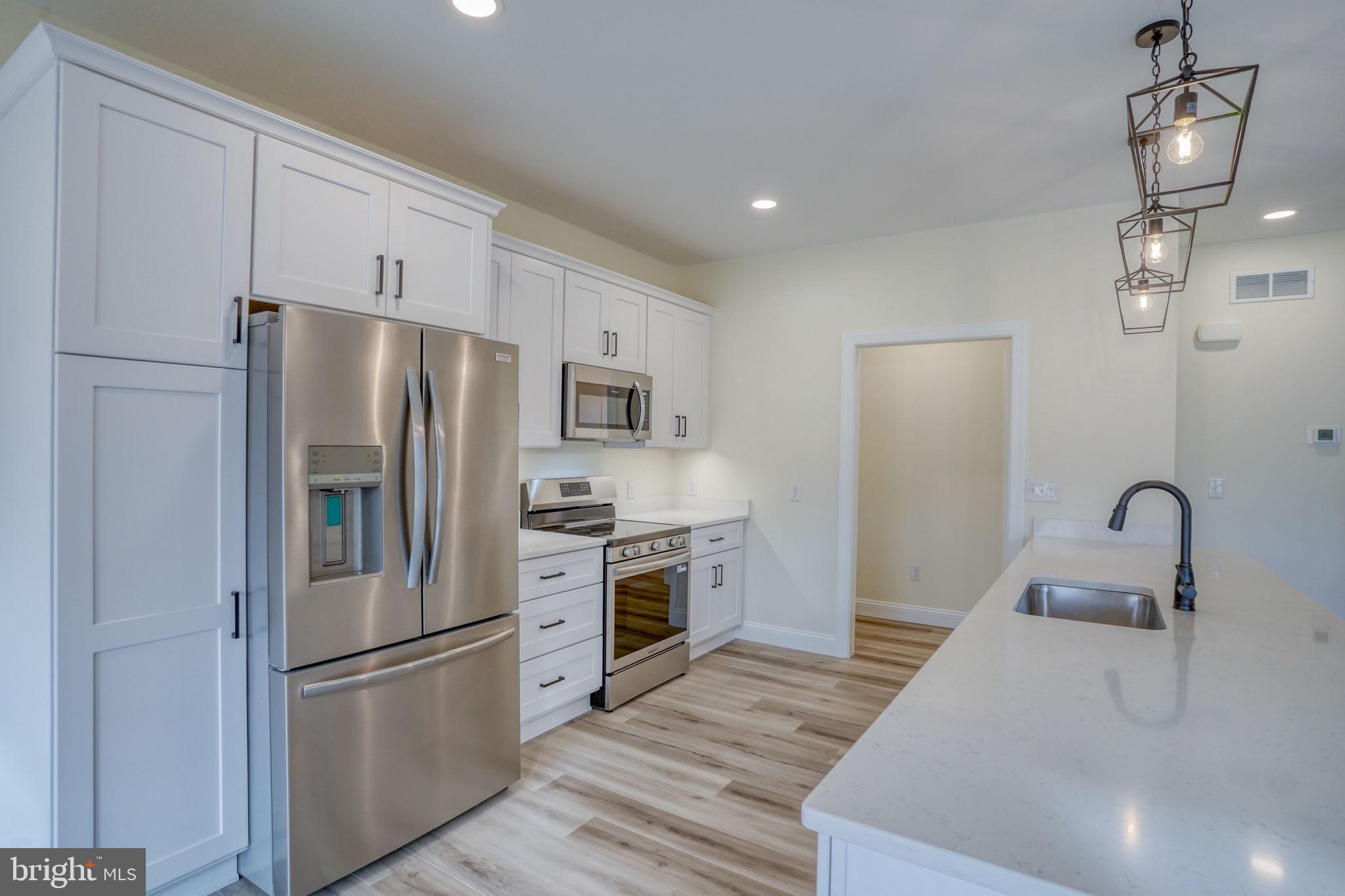 3150 Old Sharptown Road Laurel, DE 19956 - Photo 25 of 46 a kitchen with stainless steel appliances a refrigerator sink and microwave
