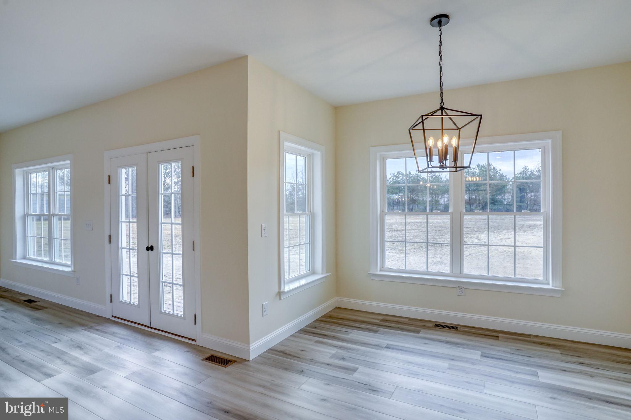 3150 Old Sharptown Road Laurel, DE 19956 - Photo 27 of 46 a view of an empty room with wooden floor and a window