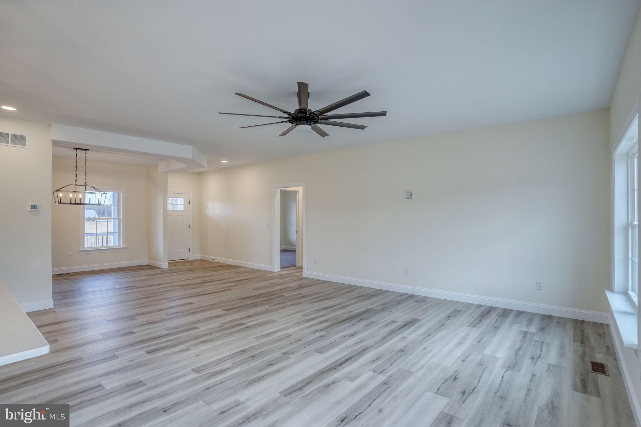 3150 Old Sharptown Road Laurel, DE 19956 - Photo 28 of 46 a view of an empty room with wooden floor and a ceiling fan