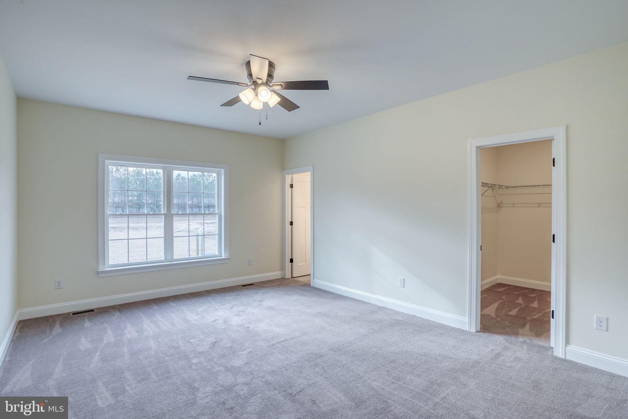 3150 Old Sharptown Road Laurel, DE 19956 - Photo 33 of 46 an empty room with chandelier fan and windows