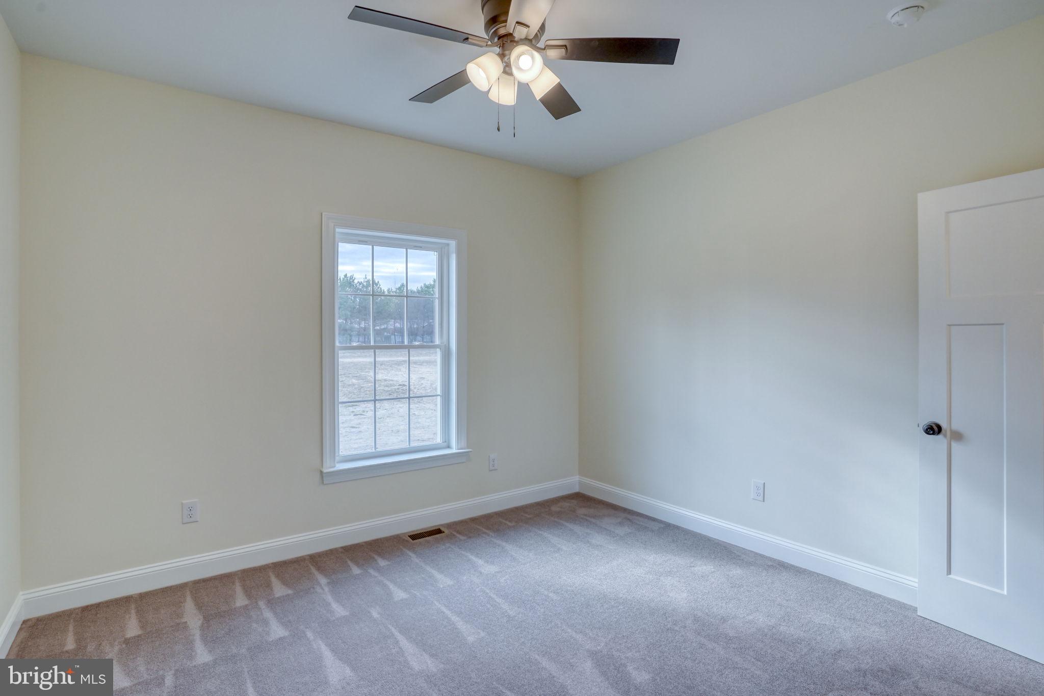 3150 Old Sharptown Road Laurel, DE 19956 - Photo 41 of 46 an empty room with a window and a fan