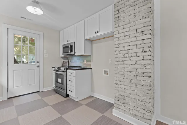 a kitchen with stainless steel appliances a stove and a refrigerator