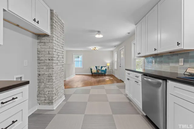 a large kitchen with stainless steel appliances granite countertop a stove a sink and a refrigerator