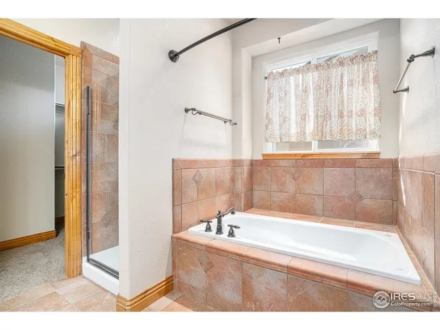 a bathroom with a sink a toilet a large mirror and shower