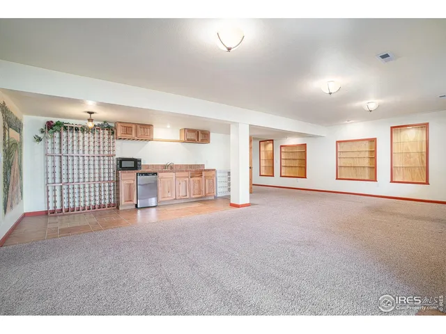 a living room with furniture large window and wooden floor