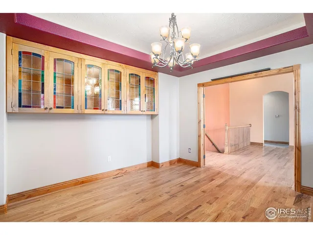 a view of a living room and kitchen with wooden floor