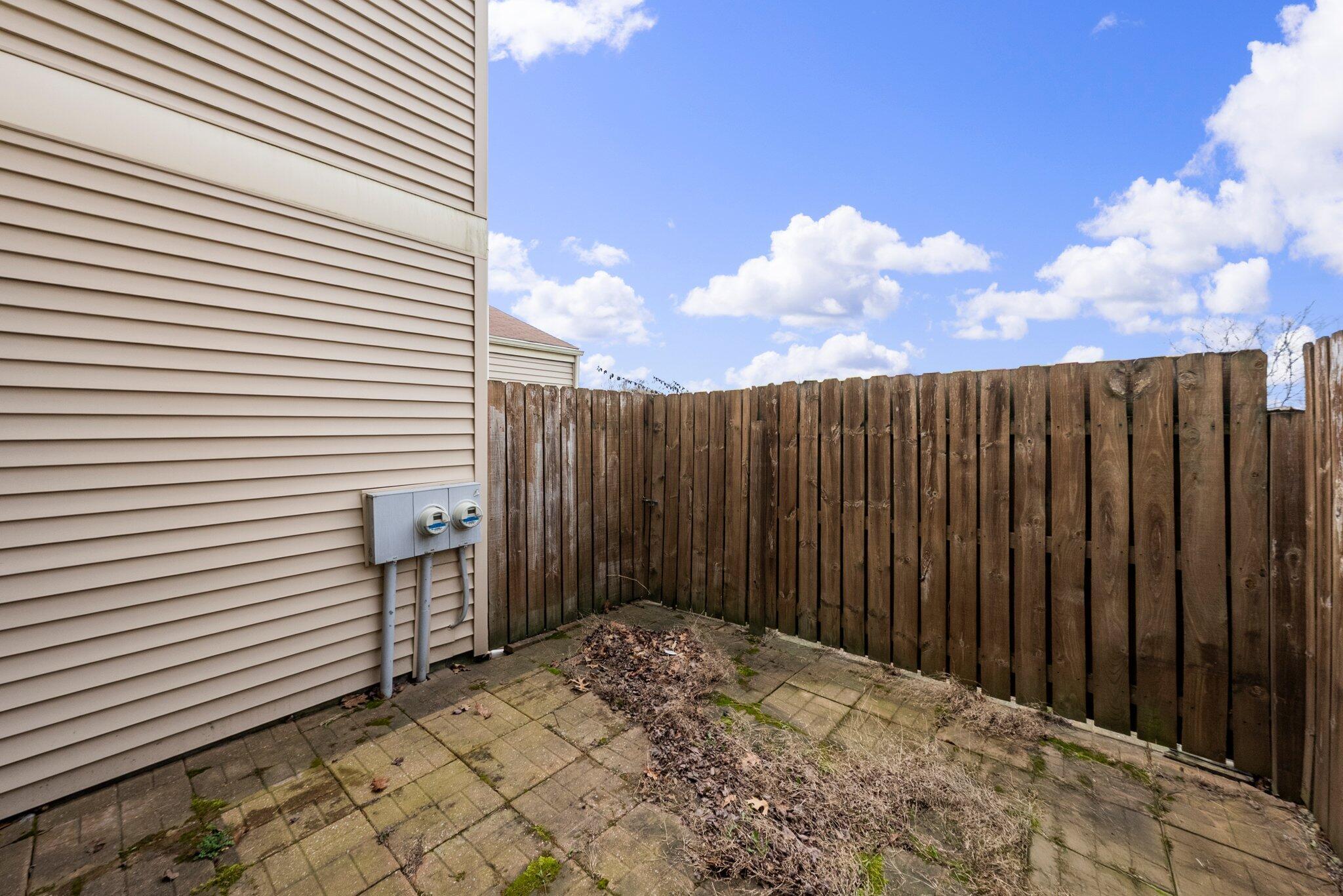 2052 Quail Ridge Street Columbus, OH 43229 - Photo 26 of 31 back patio, gated access to green space from sliding door in living room