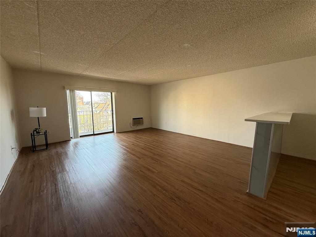 281 Park Street, Unit 3B Hackensack, NJ 07601 - Photo 2 of 11 a view of empty room with wooden floor and fan