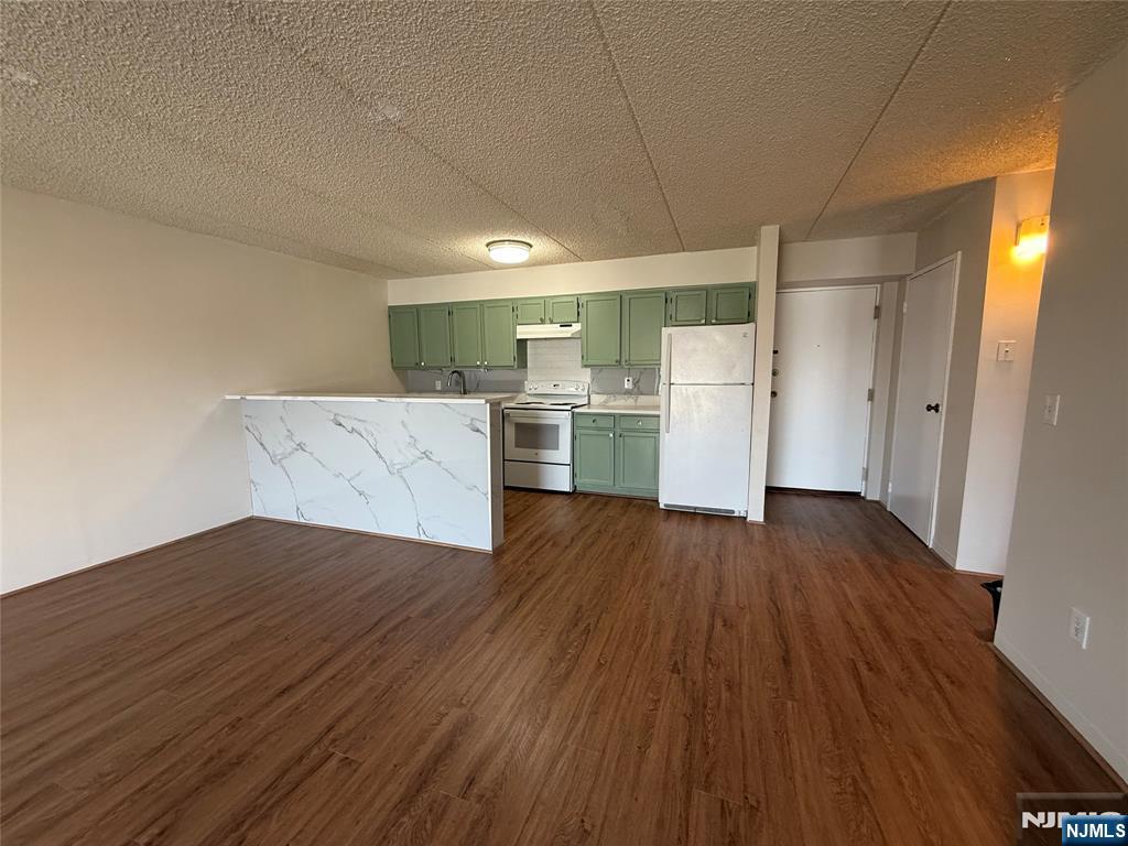 281 Park Street, Unit 3B Hackensack, NJ 07601 - Photo 4 of 11 a kitchen with a wooden floor and cabinets