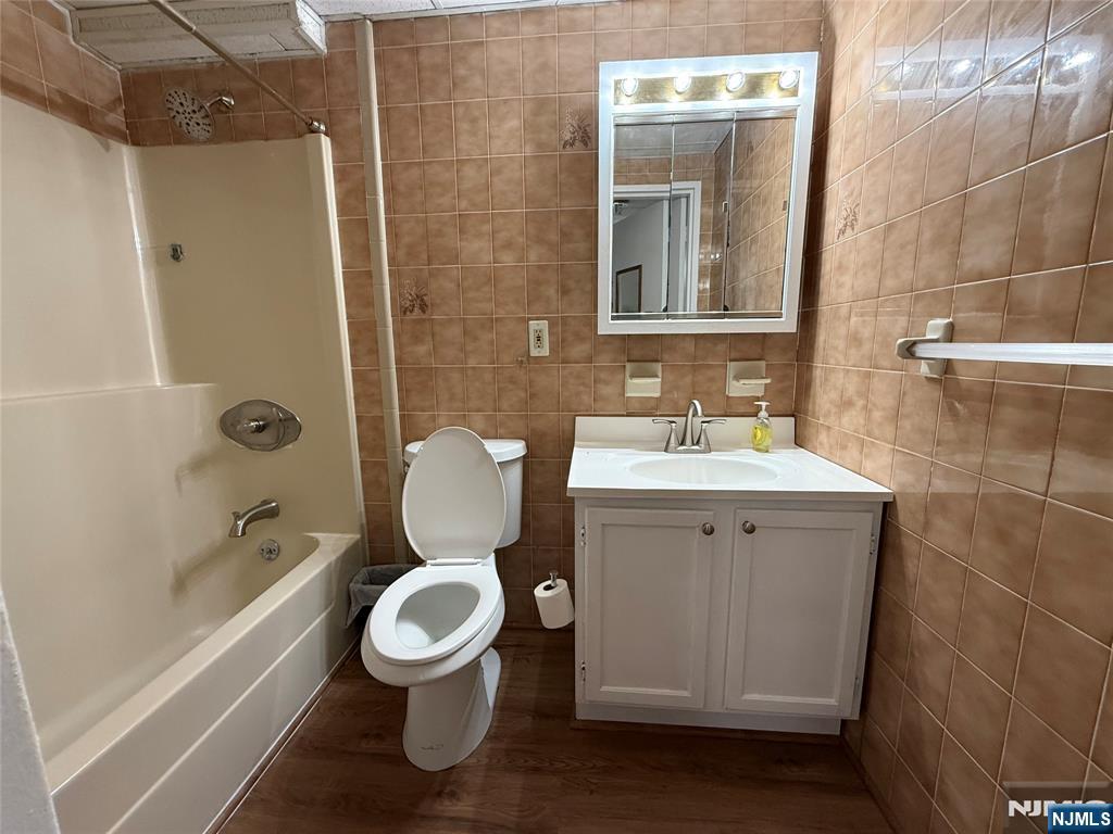 281 Park Street, Unit 3B Hackensack, NJ 07601 - Photo 7 of 11 a bathroom with a toilet sink and mirror