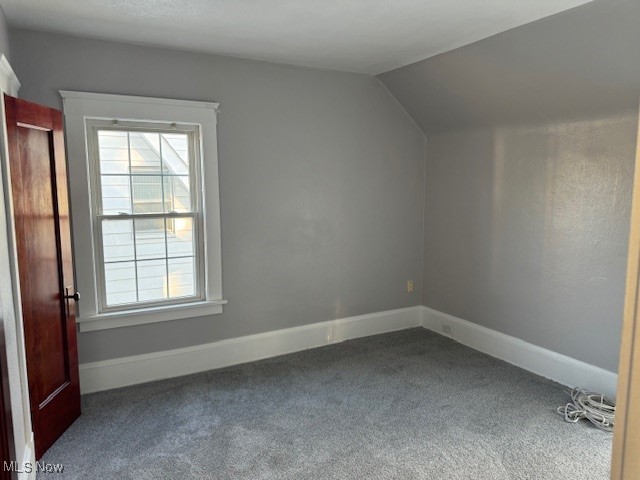 18210 Windward Road Cleveland, OH 44119 - Photo 19 of 40 Additional living space with carpet flooring, a healthy amount of sunlight, and vaulted ceiling
