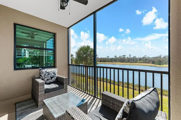 a balcony with wooden floor and outdoor seating