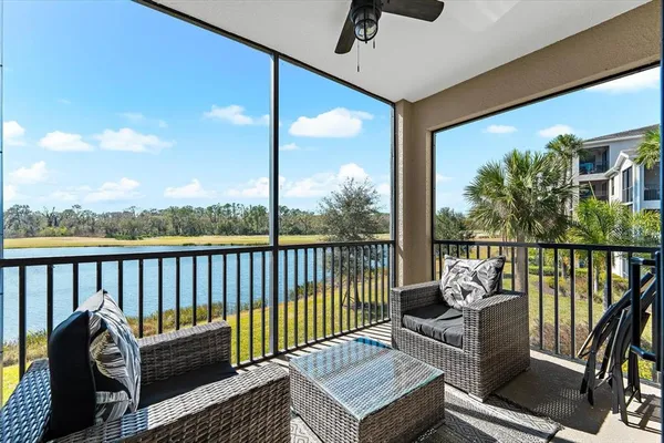 a roof deck with couches and wooden floor