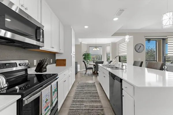 a kitchen with a sink stove top oven and microwave