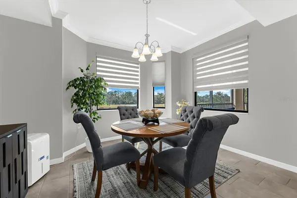 a dining room with furniture and window