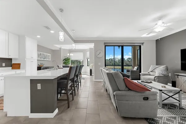 a living room with furniture a large window and a table