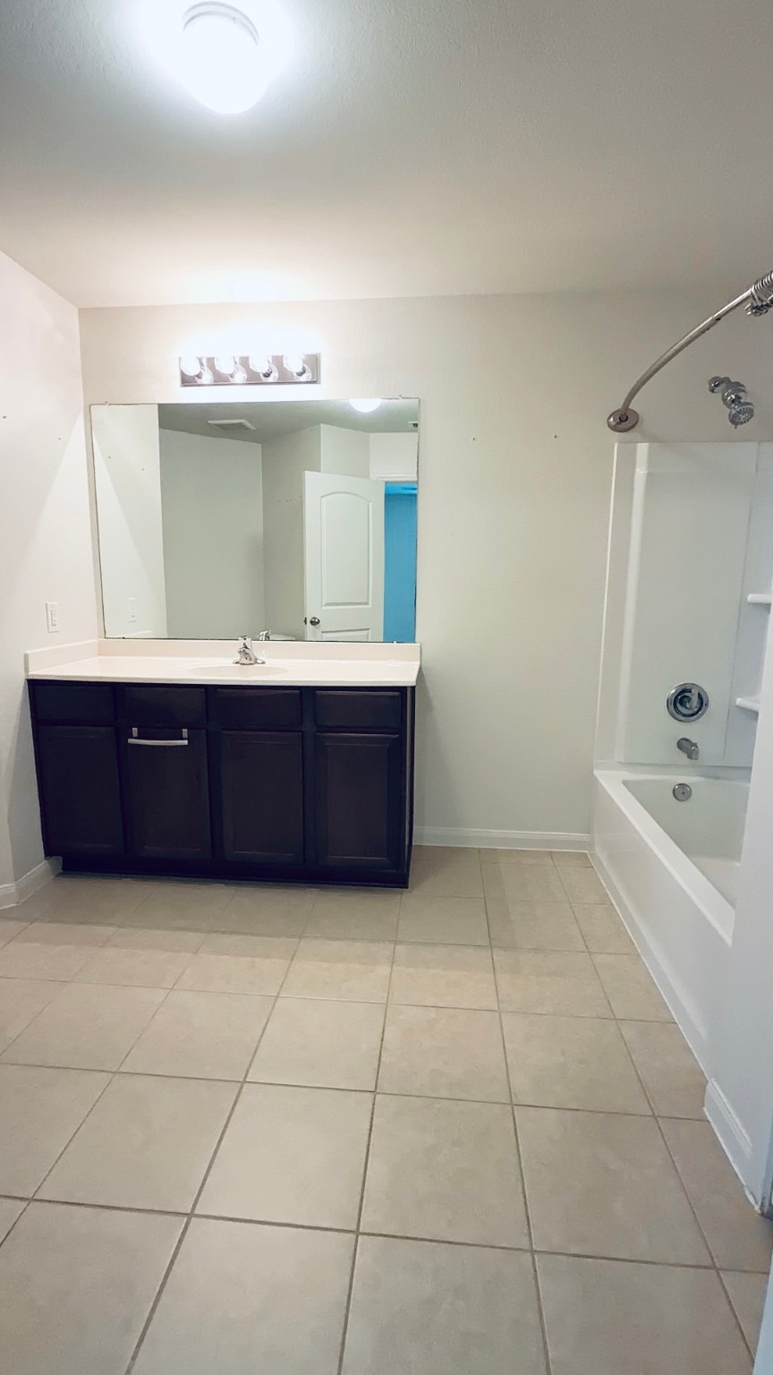 22418 Threefold Ridge Drive Hockley, TX 77447 - Photo 12 of 19 a bathroom with a tub sink and mirror