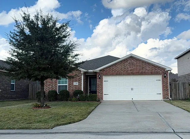 a view of a house with a yard and garage