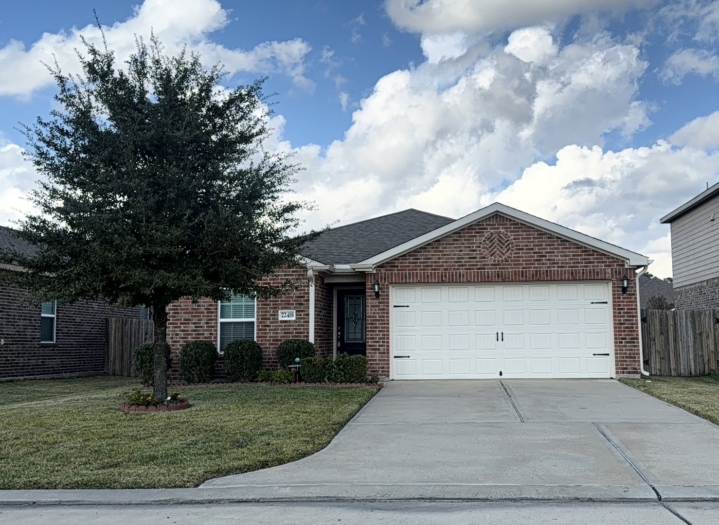 22418 Threefold Ridge Drive Hockley, TX 77447 - Photo 2 of 19 a view of a house with a yard and garage