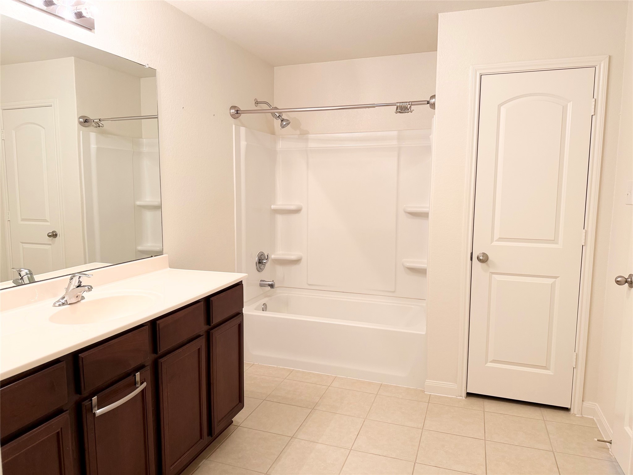 22418 Threefold Ridge Drive Hockley, TX 77447 - Photo 10 of 19 a bathroom with a bathtub sink vanity and mirror