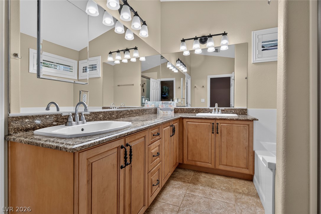 818 Manor Shores Road Henderson, NV 89002 - Photo 19 of 35 Double vanities and abundant counter space enhance this well-appointed primary bathroom.