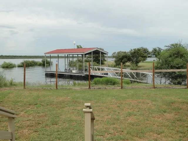 a view of a lake with a table and chairs