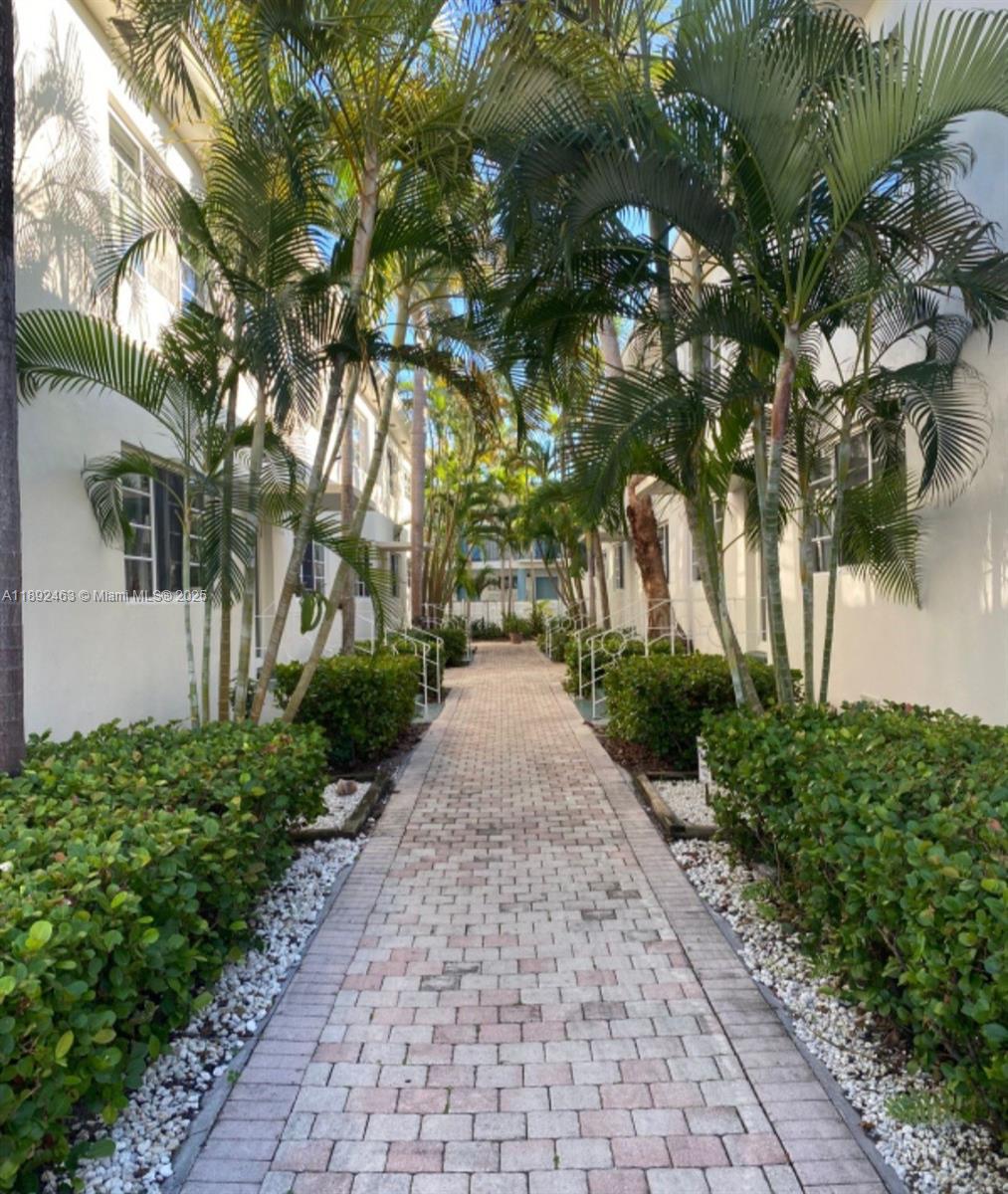 340 84th Street, Unit 2 Miami Beach, FL 33141 - Photo 1 of 10 a view of a pathway with a yard