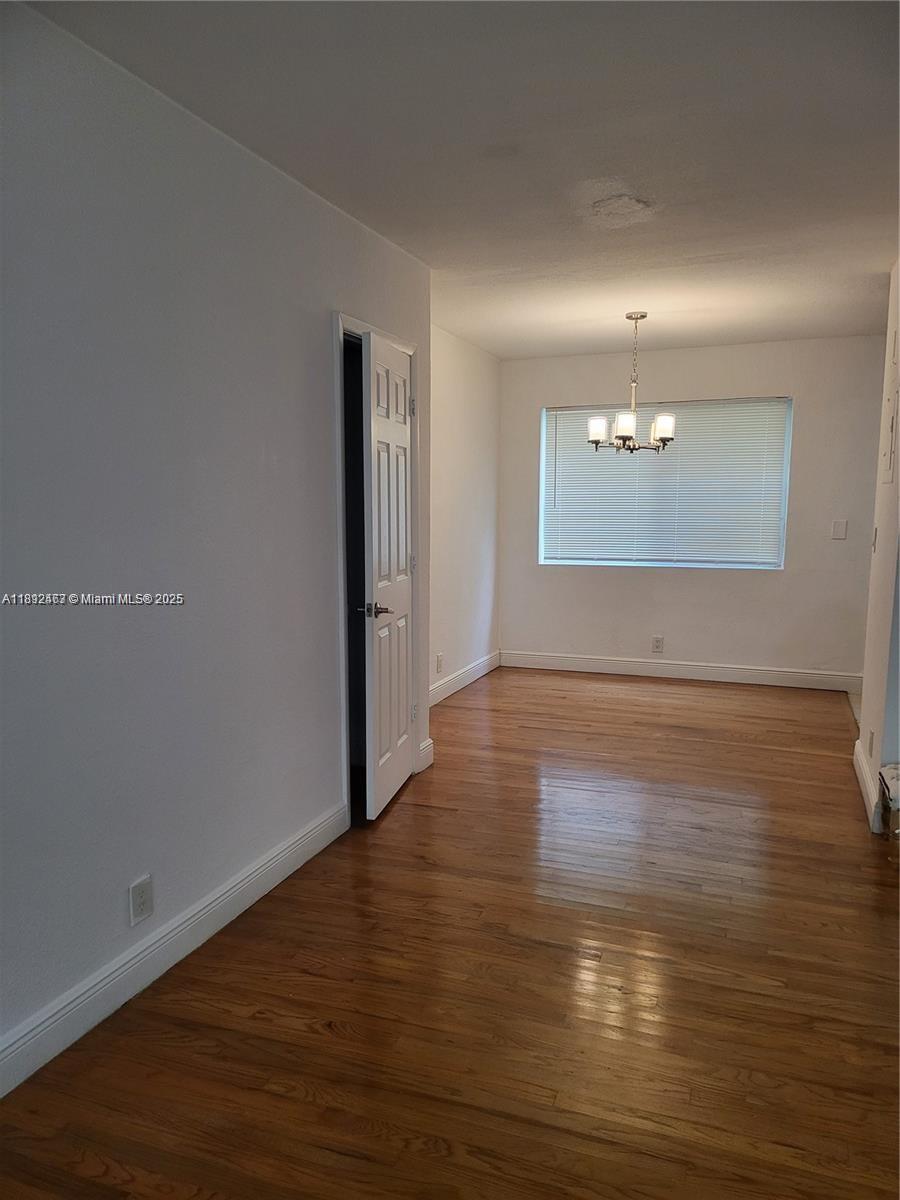 340 84th Street, Unit 2 Miami Beach, FL 33141 - Photo 3 of 10 a view of an empty room with wooden floor