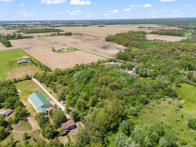 an aerial view of ocean with residential house and outdoor space