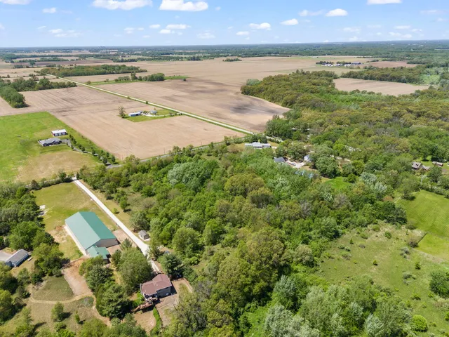an aerial view of ocean with residential house and outdoor space