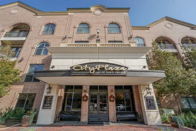 a view of a cars park in front of a building