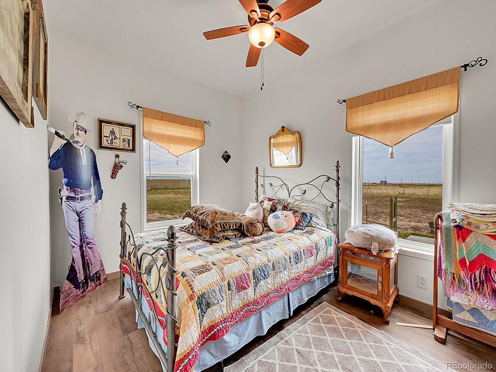 10660 Schumaker Road Bennett, CO 80102 - Photo 12 of 50 a bedroom with bed and a window
