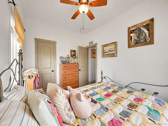 a bedroom that has a bed and a chandelier