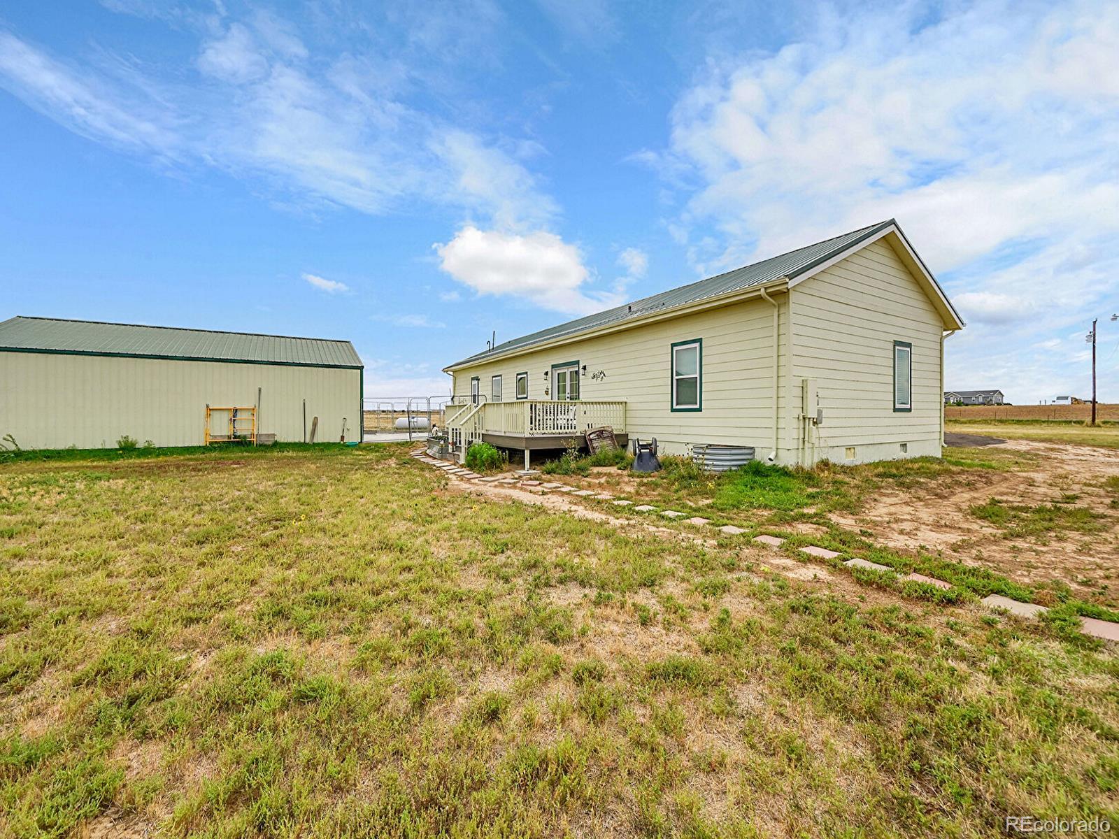 10660 Schumaker Road Bennett, CO 80102 - Photo 21 of 50 a house view with a garden space