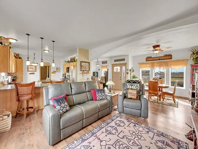 a kitchen with stainless steel appliances granite countertop a sink a stove and a refrigerator