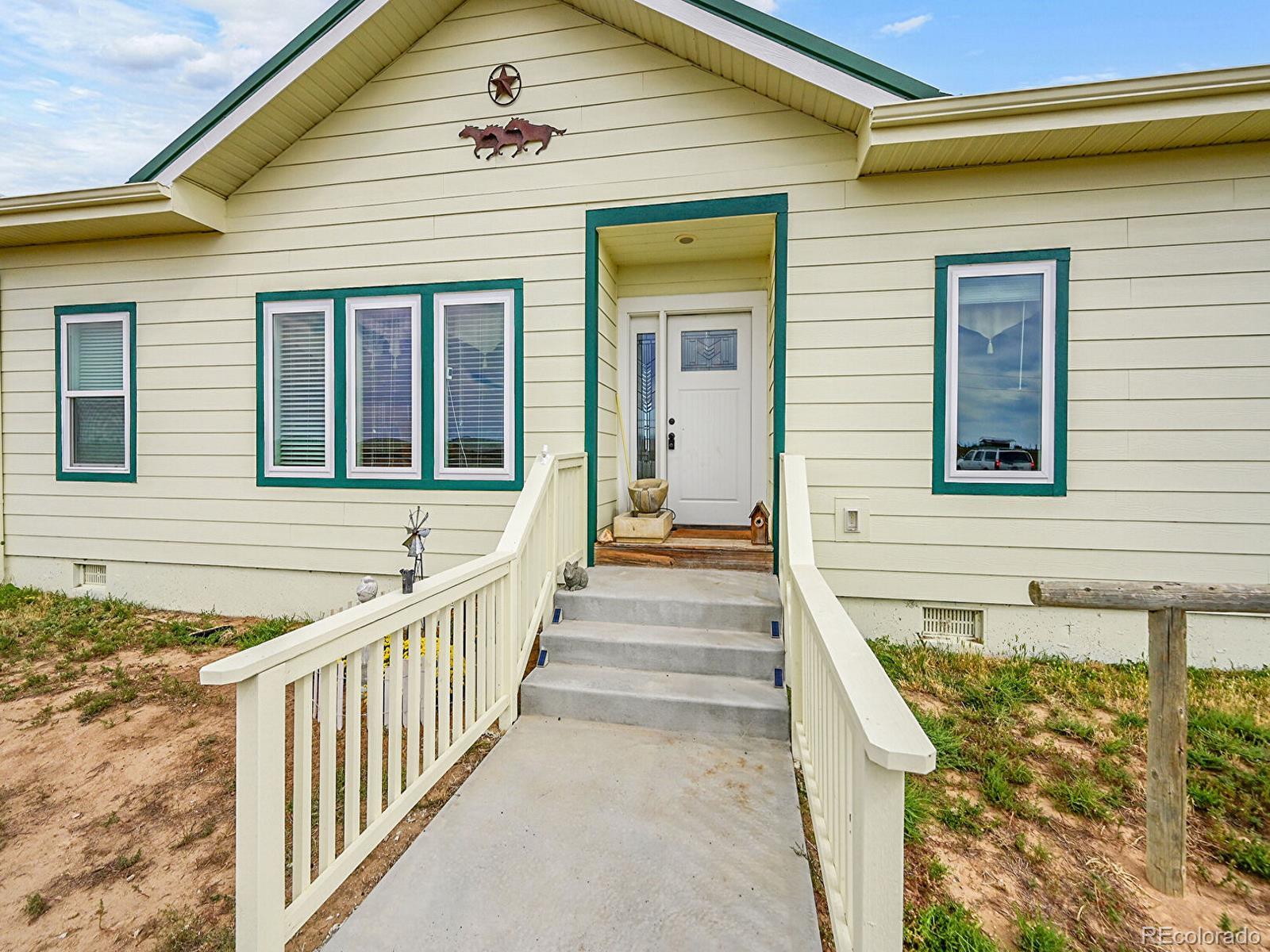 10660 Schumaker Road Bennett, CO 80102 - Photo 3 of 50 a view of a brick house with front door