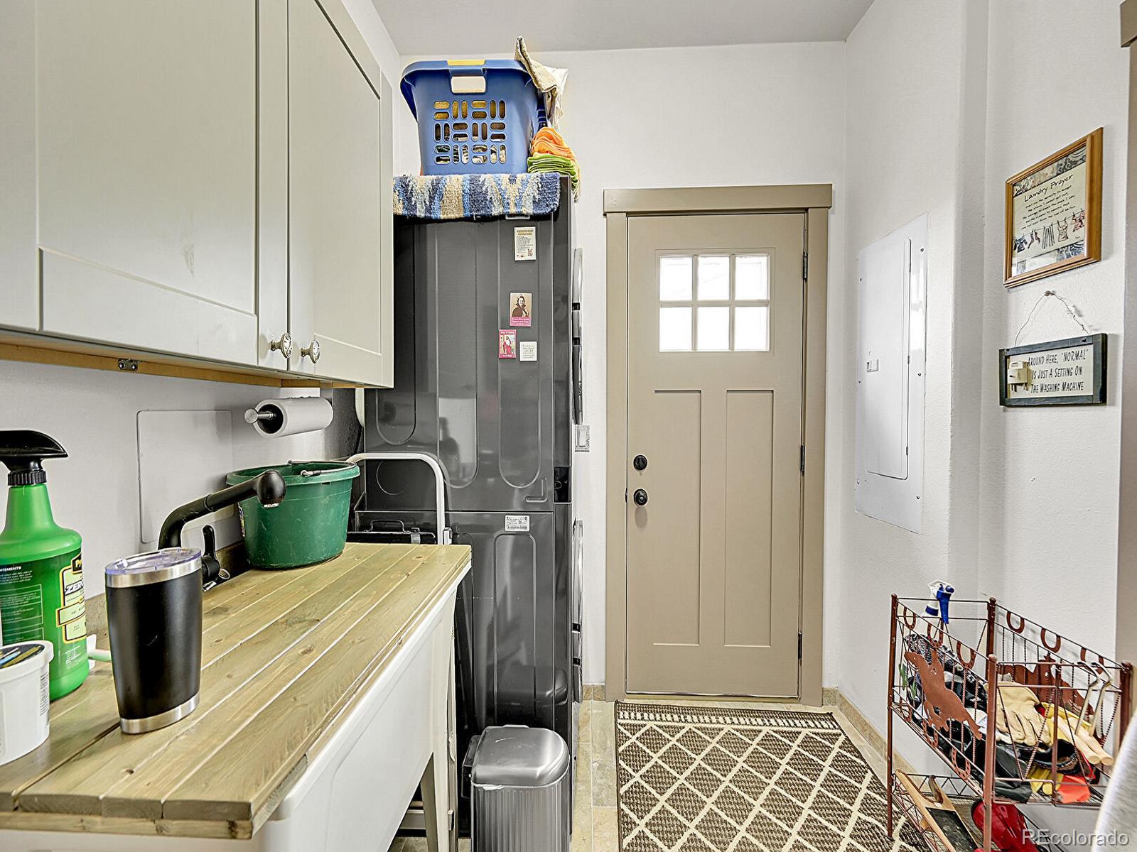 10660 Schumaker Road Bennett, CO 80102 - Photo 32 of 50 a kitchen with a refrigerator and sink