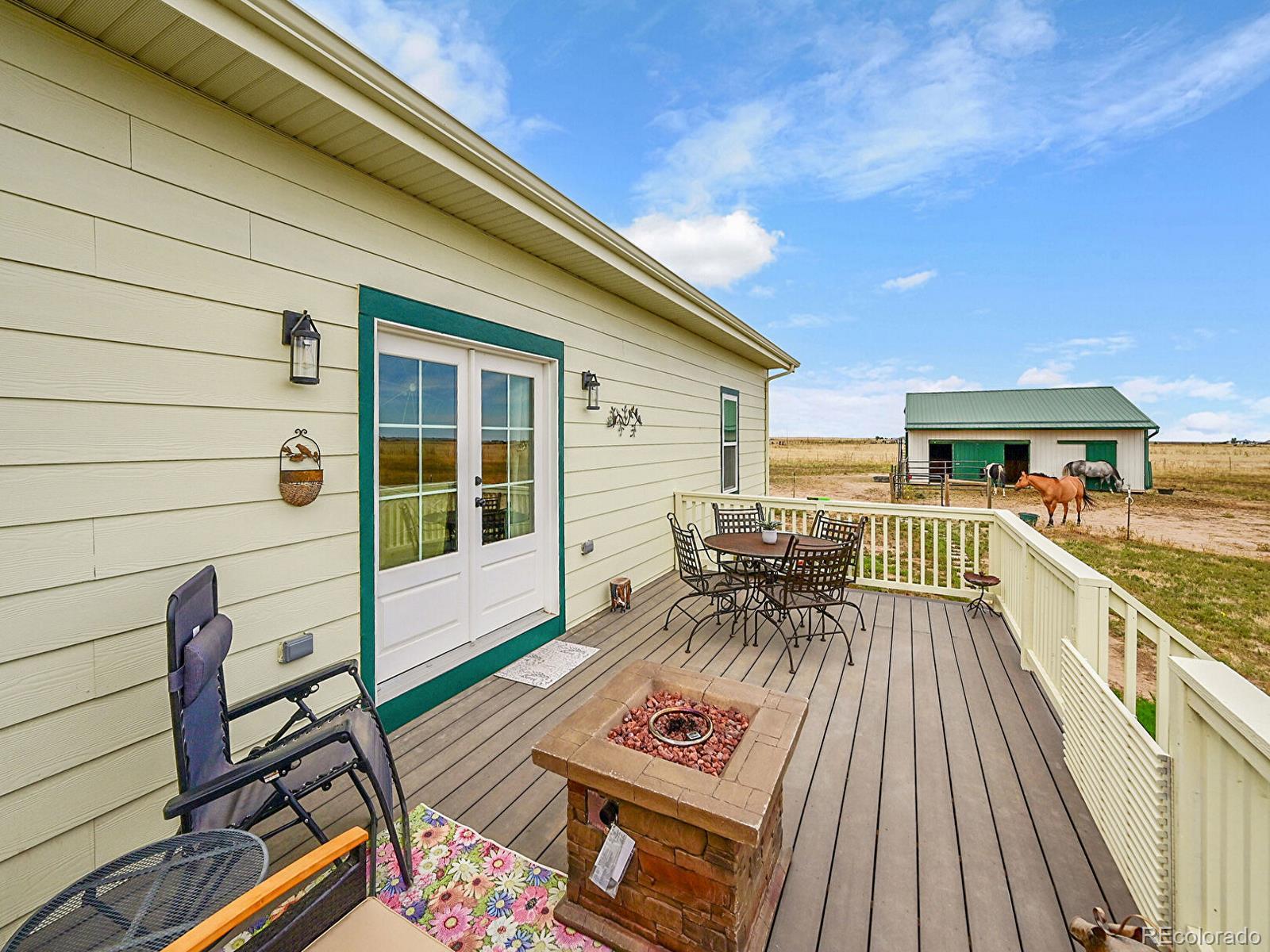 10660 Schumaker Road Bennett, CO 80102 - Photo 35 of 50 a view of balcony with chairs and wooden fence