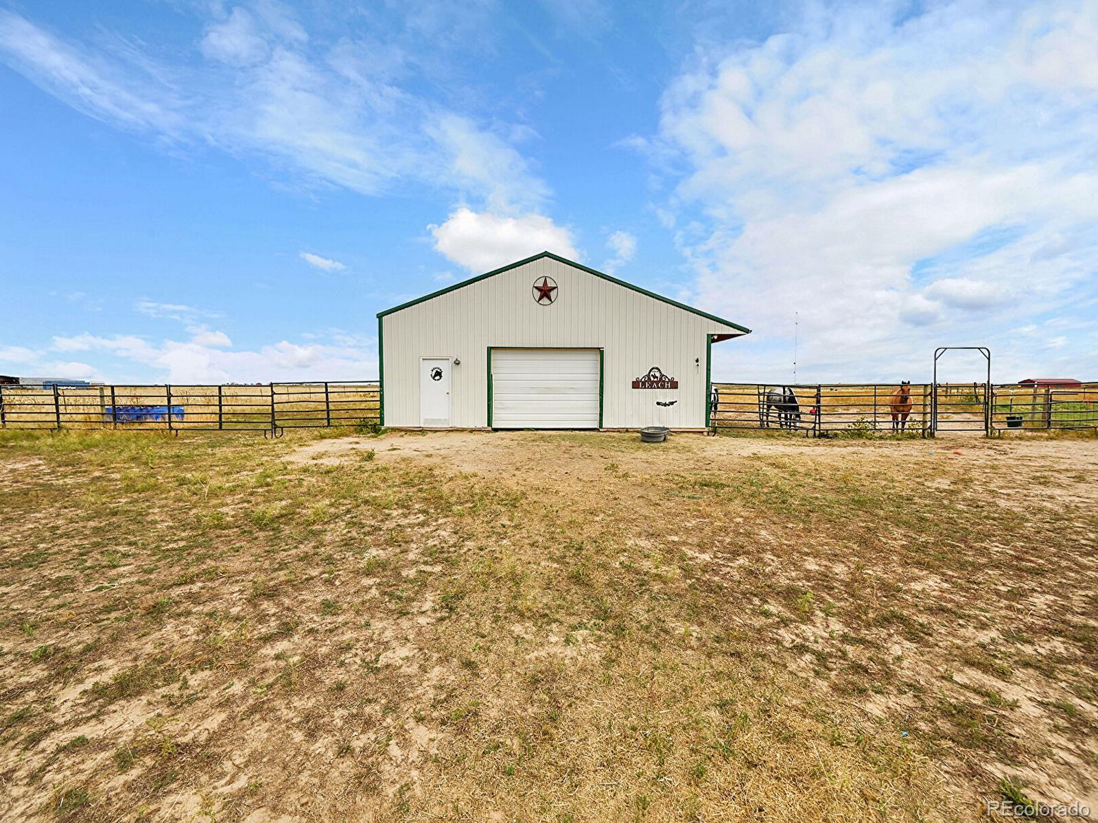 10660 Schumaker Road Bennett, CO 80102 - Photo 38 of 50 a front view of a house with a large tree