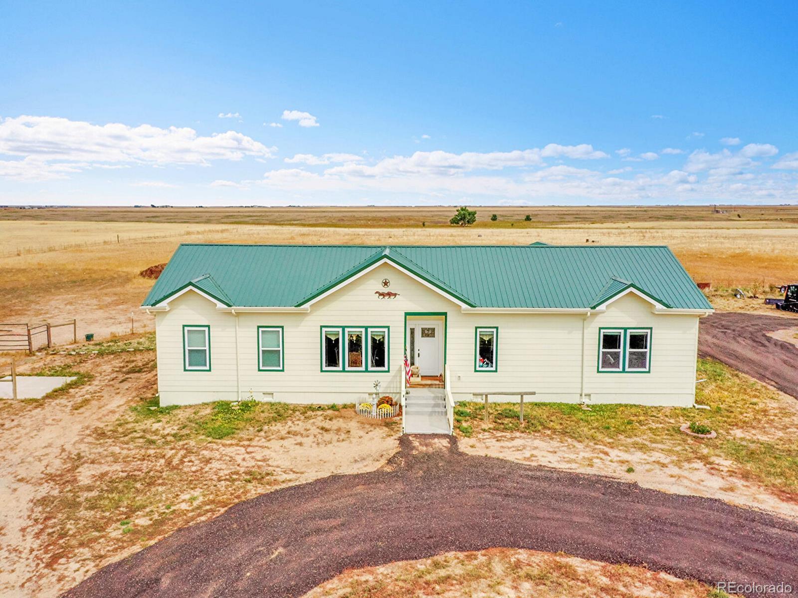 10660 Schumaker Road Bennett, CO 80102 - Photo 48 of 50 a front view of a house with a yard