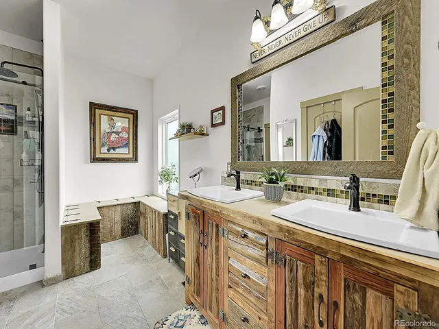 a spacious bathroom with a double vanity sink mirror and bathtub