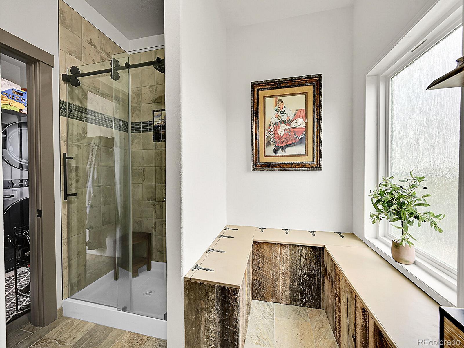 10660 Schumaker Road Bennett, CO 80102 - Photo 10 of 50 a bathroom with a bathtub and shower