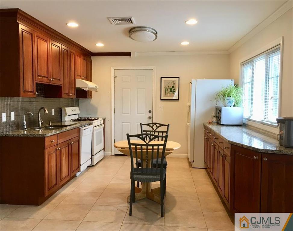23 Raleigh Road Edison, NJ 08817 - Photo 2 of 19 a kitchen with stainless steel appliances granite countertop a stove a sink and a refrigerator