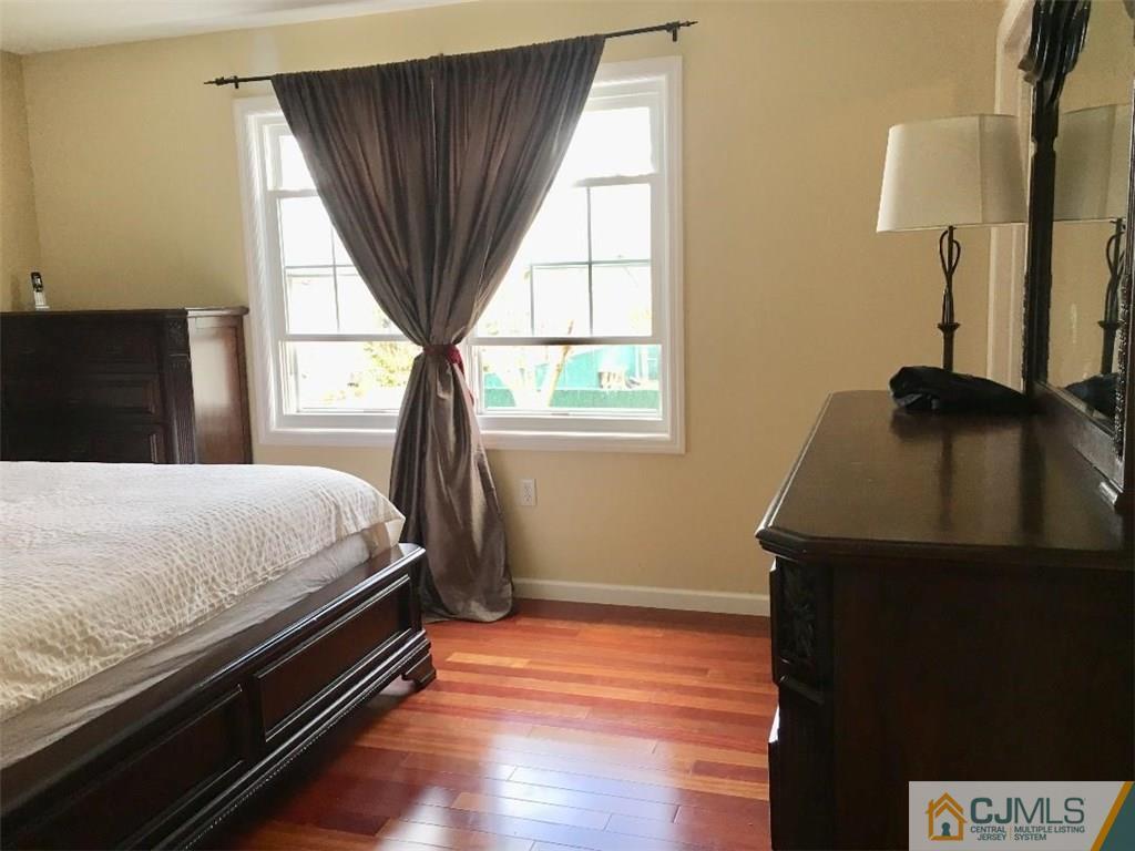 23 Raleigh Road Edison, NJ 08817 - Photo 11 of 19 a bed sitting in a bedroom next to a window